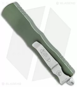 Microtech Dirac Dagger OTF Automatic Knife OD Green (2.88" Stonewash Full Serr) -Avokelavavat Sales Store Microtech Dirac Dagger OTF Auto OD Green SW Full Serr BHQ 111330 jr side