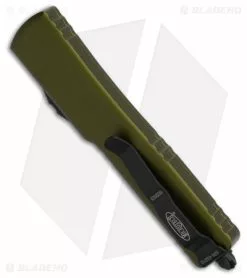 Microtech UTX-70 Dagger OTF Automatic Knife OD Green (2.4" Black Serr) -Avokelavavat Sales Store Microtech UTX 70 Dagger OTF Automatic Knife OD Green 2in Black Serr BHQ 181947 td side